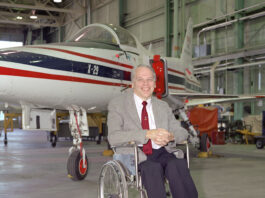 Ken Iliff’s Four-Decade Engineering Legacy at NASA A man sits in a wheelchair with an experimental aircraft in the background.