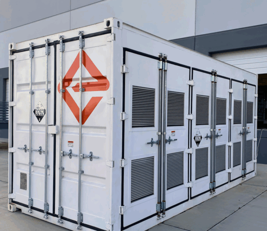 NASA Develops Groundbreaking Battery Through Engineering Innovation A white shipping-container-like enclosure, adorned with the logo for Enervenue, sits next to a building