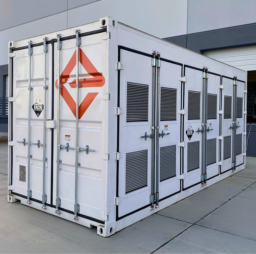 A white shipping-container-like enclosure, adorned with the logo for Enervenue, sits next to a building