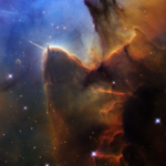 NASA Celebrates the Day of the Trifid Nebula with New Discoveries A rich, cosmic landscape is split in two. On the right side, clouds of reddish-black dust billow. On the left, stars sparkle across a dark-blue background.