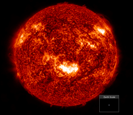 NASA’s Insights from Major Geomagnetic Storm in Two Decades A detailed, fiery image of the Sun showing bright solar flares and textured surface, with a small inset at the bottom right comparing the tiny size of Earth to the massive scale of the Sun.