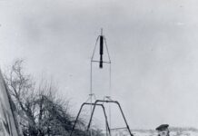 100 years later: NASA marks Goddard’s rocketry breakthrough anniversary. On a snowy March 16, 1926, Dr. Robert H. Goddard rests his hand on the testing frame supporting his liquid fuel rocket at Ward Farm in Auburn, Massachusetts. A wooden door is propped up at an angle next to the frame where Goddard’s assistant, Henry Sachs, later sheltered after lighting the rocket.