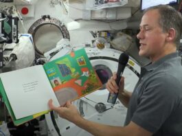 NASA Collaborations Ignite Worldwide STEM Education Initiatives NASA astronaut Thomas Marshburn, holding the book