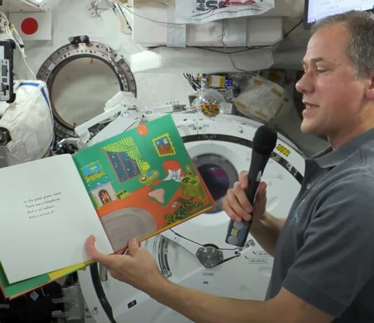 NASA Collaborations Ignite Worldwide STEM Education Initiatives NASA astronaut Thomas Marshburn, holding the book