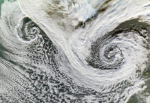 NASA Studies Cyclones in Iceland Two cyclones swirl south of Iceland in this satellite image. While the two storms