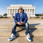 Edward Gonzales Promotes Inclusive Work Environment at NASA Edward Gonzales sitting with his hands folded on the steps in front of the Lincoln Memorial in Washington, DC.