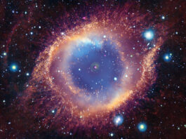 NASA Uncovers X-ray Evidence of Annihilated Planet The Helix Nebula is a cloud of gas ejected by a dying star, known as a white dwarf. In the composite image, the cloud of gas strongly resembles a creature’s eye. Here, a hazy blue cloud is surrounded by misty, concentric rings of pale yellow, rose pink, and blood orange. Each ring appears dusted with flecks of gold, particularly the outer edges of the eye-shape. The entire image is speckled with glowing dots in blues, whites, yellows, and purples. At the center of the hazy blue gas cloud, is a bright white dot with a pink outer ring, and a smaller white dot.