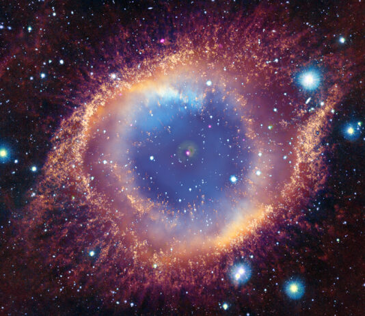 NASA Uncovers X-ray Evidence of Annihilated Planet The Helix Nebula is a cloud of gas ejected by a dying star, known as a white dwarf. In the composite image, the cloud of gas strongly resembles a creature’s eye. Here, a hazy blue cloud is surrounded by misty, concentric rings of pale yellow, rose pink, and blood orange. Each ring appears dusted with flecks of gold, particularly the outer edges of the eye-shape. The entire image is speckled with glowing dots in blues, whites, yellows, and purples. At the center of the hazy blue gas cloud, is a bright white dot with a pink outer ring, and a smaller white dot.