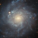 NASA’s Hubble Investigates Stellar Creation in Spiral Galaxy NASA Logo