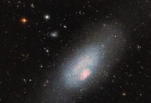 Hubble Captures Stunning Image of Massive Stars – NASA A pale blue dwarf galaxy on the black backdrop of space with some faraway galaxies. The galaxy itself resembles a fuzzy cloud of tightly packed stars, with a broad halo of stars dispersed around it. Spread across the galaxy’s core are several small, glowing patches of gas where there is a concentration of very hot stars.