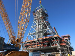 NASA Prepares Artemis II Hardware at Kennedy Space Center Teams at Bechtel National, Inc. use a crane to lift Module 4 into place atop the mobile launcher 2 tower chair at its Kennedy Space Center park site on January 3, 2025. Module 4 is the first of seven modules that will be stacked vertically to make up the almost 400-foot launch tower that will be used beginning with the Artemis IV mission.