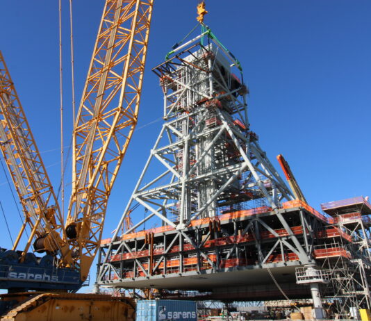 NASA Prepares Artemis II Hardware at Kennedy Space Center Teams at Bechtel National, Inc. use a crane to lift Module 4 into place atop the mobile launcher 2 tower chair at its Kennedy Space Center park site on January 3, 2025. Module 4 is the first of seven modules that will be stacked vertically to make up the almost 400-foot launch tower that will be used beginning with the Artemis IV mission.