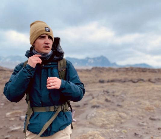 NASA’s Dr. Michael Thorpe: Expert in Sedimentary and Planetary Geology A man wearing a tan beanie and a blue winter jacket with a hiking backpack strapped around him. He