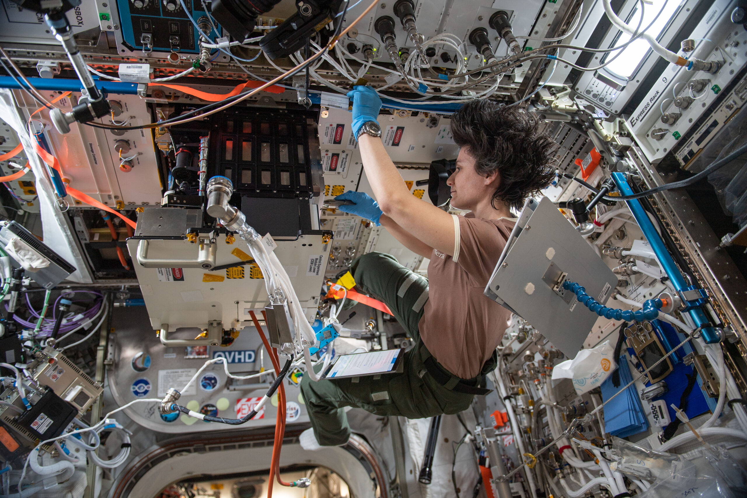 iss067e253411.jpg An astronaut floats aboard the International Space Station while conducting an experiment.