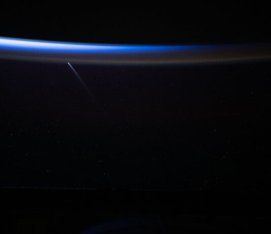 NASA Reports Sighting of Ancient Comet A bright blue arc appears in the darkness of space. The comet streaks upward, almost perpendicular.