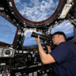 Astronaut Insights: 25 Years in Low Earth Orbit NASA astronaut Matthew Dominick points his camera through a cupola window as the International Space Station orbits 262 miles above the Atlantic Ocean off the coast of Africa.