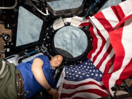 NASA Marks 25 Years of Human Space Exploration NASA astronaut and Expedition 73 Flight Engineer Jonnny Kim poses for a portrait with the American flag on the Fourth of July, or Independence Day, inside the International Space Station