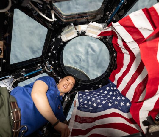NASA Marks 25 Years of Human Space Exploration NASA astronaut and Expedition 73 Flight Engineer Jonnny Kim poses for a portrait with the American flag on the Fourth of July, or Independence Day, inside the International Space Station