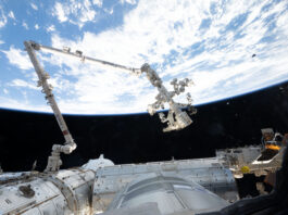 NASA Leverages Robotics for Assistance The 57.7-foot-long Canadarm2 robotic arm extends from the International Space Station. The arm is long, cylindrical, and white, with several joints that are bent to the right (at left in the image) and downward (at center). Earth makes a bright white and blue background for the top half of the photo. Our home planet contrasts starkly with the darkness of space.