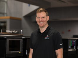 Joe Pavicic: NASA’s Artemis Mission Highlight Image shows man smiling in black shirt with NASA