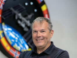 David Korth Appointed Deputy for NASA’s Safety Directorate A white, smiling male in a blue polo stands with arms folded in front of the International Space Station logo.