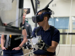New Astronaut Trainees Begin Duties at NASA’s Johnson Space Center An astronaut wears a VR headset and holds controllers in his hands during a training exercise.