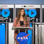 Nilufar Ramji: Propelling Johnson’s Major Advances at NASA A woman dressed in a light brown suit smiles and stands at a podium during an event.