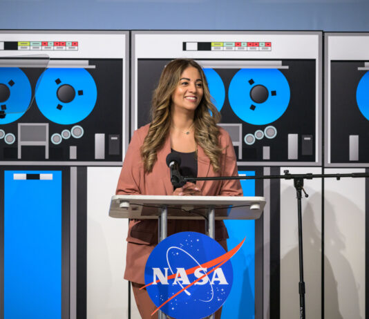 Nilufar Ramji: Propelling Johnson’s Major Advances at NASA A woman dressed in a light brown suit smiles and stands at a podium during an event.