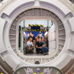 NASA’s Kibo Challenge Revolutionizes Robotics Programming A group of six people pose inside a large circular module in a space station habitat mockup.