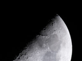 NASA’s Ambitious Plans for Lunar Exploration The Moon is lit so only half of it, diagonally, is visible. Along that line, craters of different sizes are visible. As you look toward the right, you can see light and dark gray areas on the Moon
