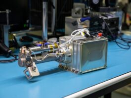 NASA Moon Instrument Set for Second Chance at Lunar Operations Image shows a silver square science instrument on blue table