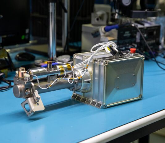 NASA Moon Instrument Set for Second Chance at Lunar Operations Image shows a silver square science instrument on blue table