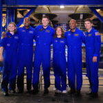 NASA Hosts Artemis II Crews for Media Day Event Six astronauts, all in blue jumpsuits, pose together for a photo.