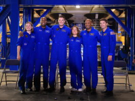 NASA Hosts Artemis II Crews for Media Day Event Six astronauts, all in blue jumpsuits, pose together for a photo.