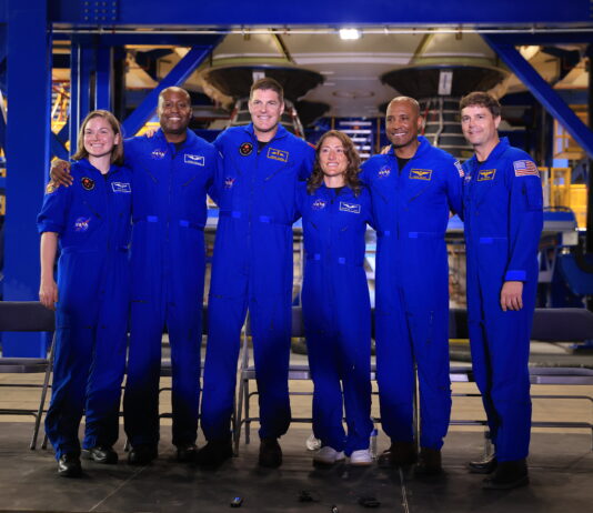 NASA Hosts Artemis II Crews for Media Day Event Six astronauts, all in blue jumpsuits, pose together for a photo.
