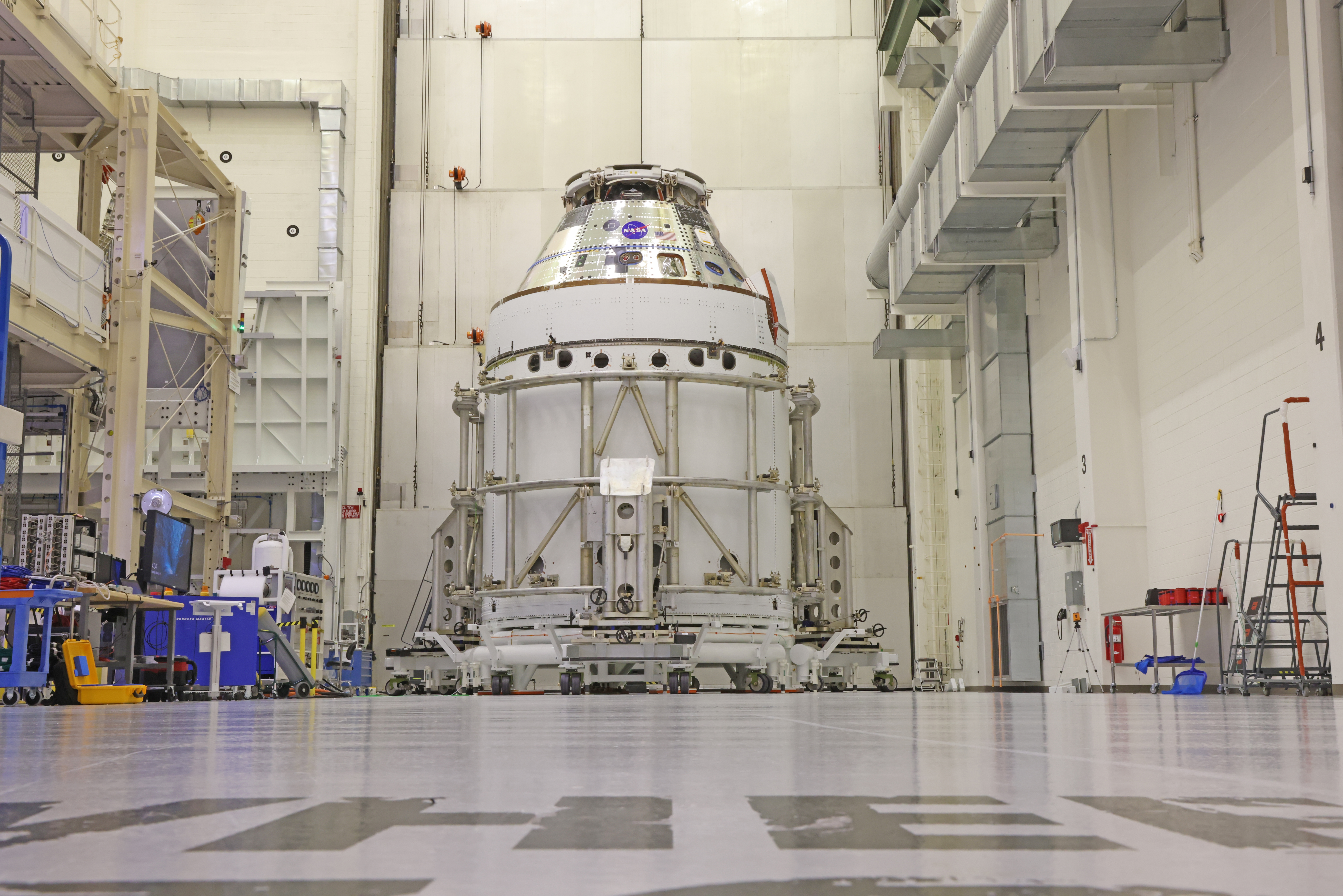 ksc 20250318 ph geb01 20250318 0023 copy.jpg The Artemis II Orion spacecraft sits in the transfer aisle in the Neil A. Armstrong Operations and Checkout Building at NASA’s Kennedy Space Center in Florida following the installation of three spacecraft adapter jettison fairings on Wednesday, March 19, 2025. The fairings encapsulate the service module protect the solar array wings, shielding them from the heat, wind, and acoustics of launch and ascent, plus help redistribute the load between Orion and the massive thrust of the SLS (Space Launch System) rocket during liftoff and ascent. Once the spacecraft is above the atmosphere, the three fairing panels will separate from the service module reducing the mass of the spacecraft.