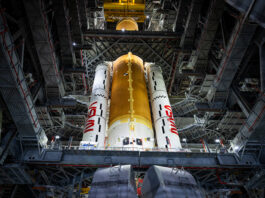 NASA Completes Artemis II Core Stage Integration The Artemis II core stage (a butterscotch orange cylinder in the middle) and solid rocket boosters (the white cylinders, branded with the NASA