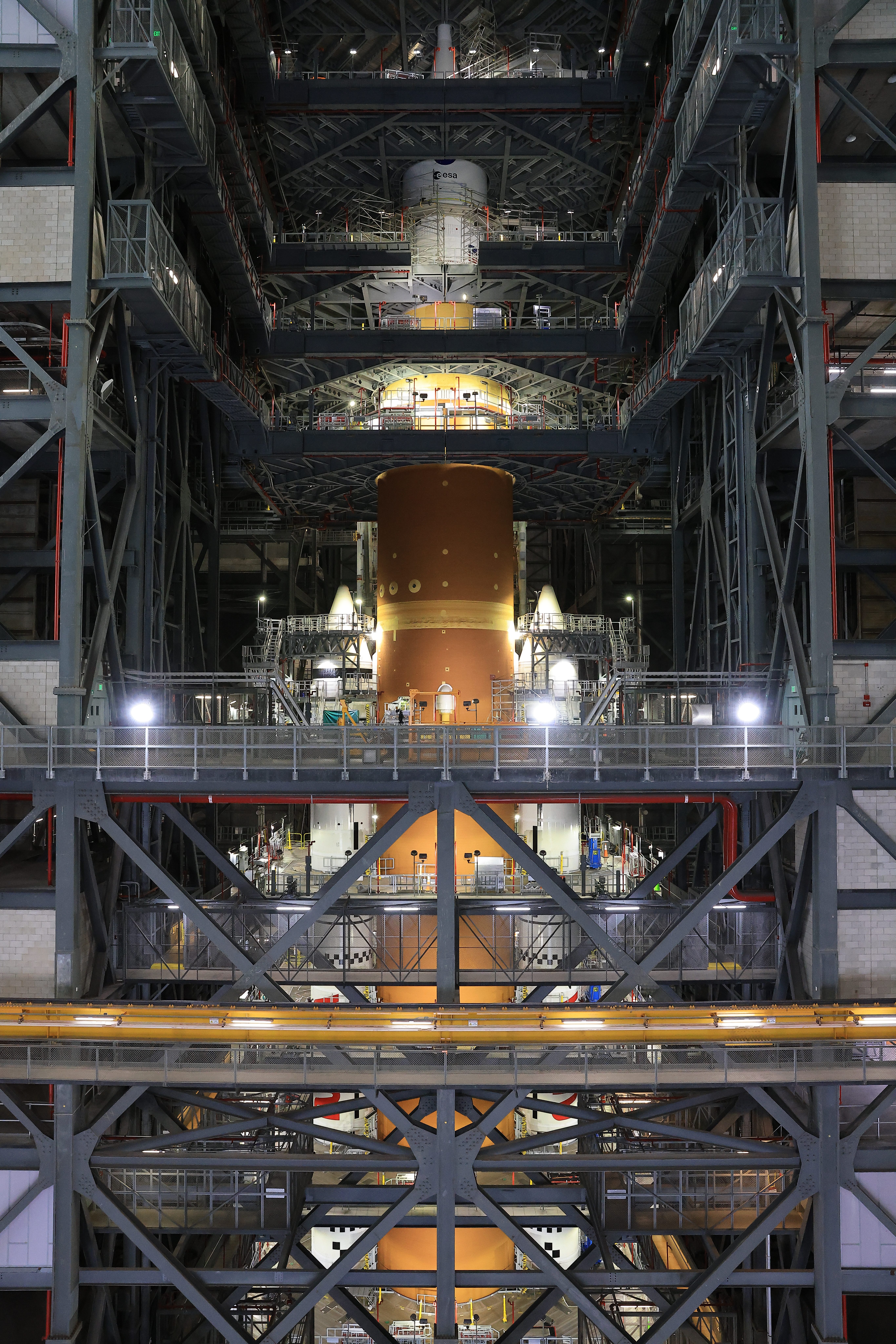 ksc 20251020 ph kls01 0050orig rotated.jpg The orange core stage of the Artemis II rocket with white boosters on each side fully stacked inside the Vehicle Assembly Building at NASA