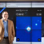 Join NASA’s Citizen Science Projects: A Guide Photo of a man standing next to a large projected image of the Disk Detective website