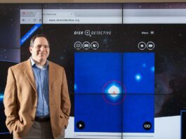 Join NASA’s Citizen Science Projects: A Guide Photo of a man standing next to a large projected image of the Disk Detective website