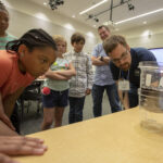 NASA, Education Dept. Partner on STEM Initiative in Washington Elementary school students observe a science experiment with a NASA researcher.