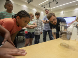 NASA, Education Dept. Partner on STEM Initiative in Washington Elementary school students observe a science experiment with a NASA researcher.
