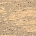 NASA Pursues Clay Research: Ongoing Scientific Exploration A color photo from the Martian surface shows an area of pale brownish-orange rocks, mostly medium to large and flat, with varied edges and cracks. Among them are numerous smaller rocks that are more jagged, poking up. In between the rocks the area is covered in fine soil, slightly darker-toned than the rocks.