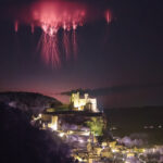 h3 tag: NASA Captures Sprites Above Château de Beynac Red streaks branch out high in the sky above a city lit up at night.