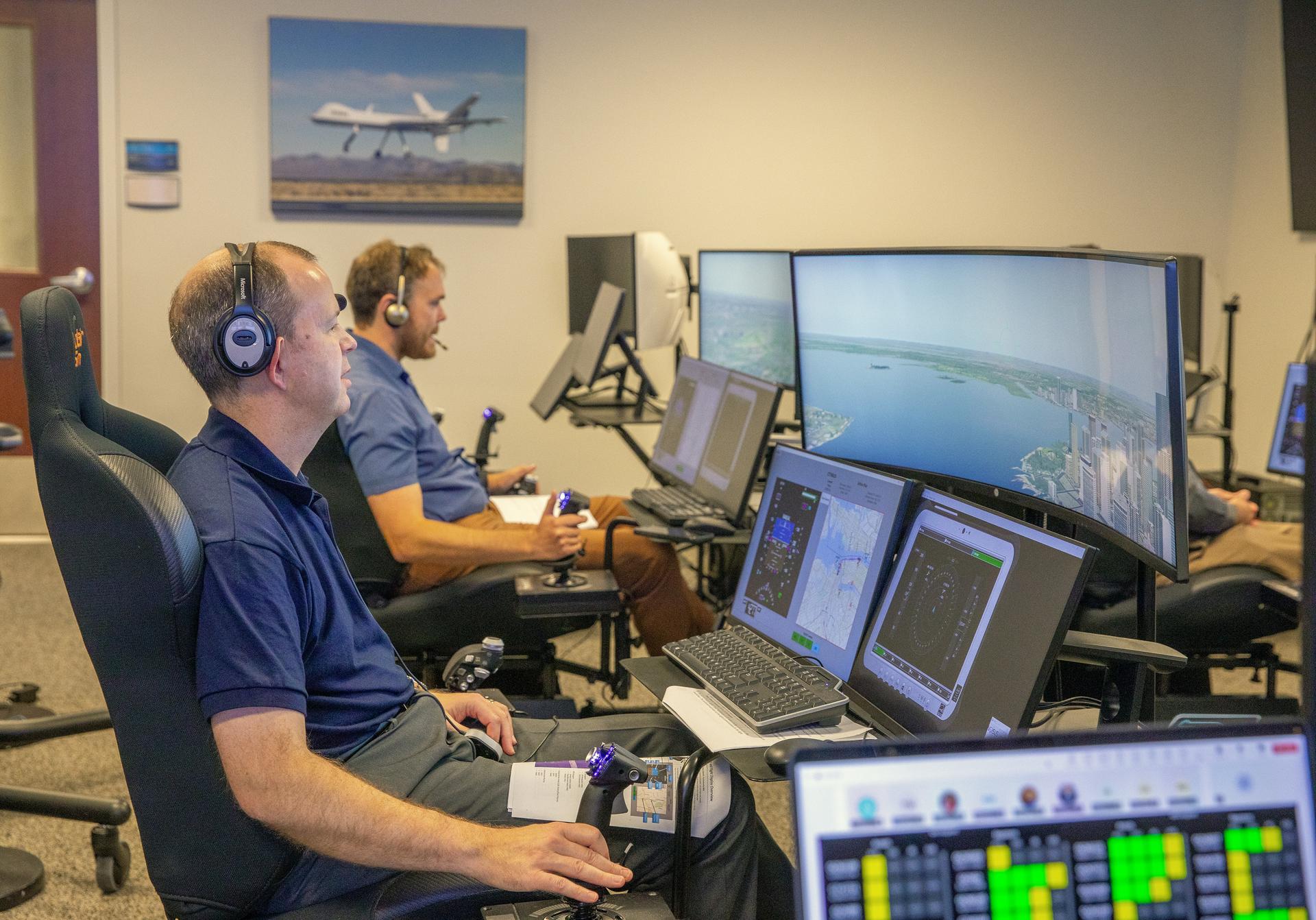 nasa software catalog release july 16.jpg Andy Burroughs (left) and Paul Friz in the roles of air taxi pilots running through air taxi integration simulations focusing on urban air space at NASA’s Langley Research in Hampton, Virginia on Sept. 25, 2024.