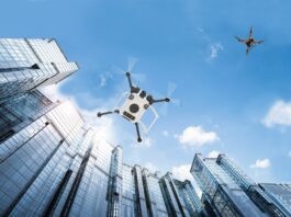 Charting Flight Paths for Drones in Controlled Airspace Autonomous vehicle drones in flight among city buildings.