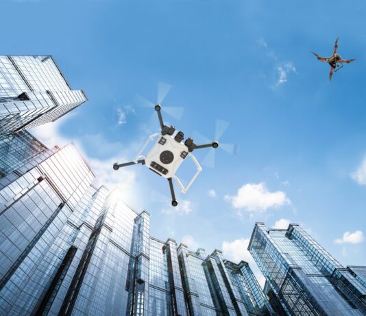 Charting Flight Paths for Drones in Controlled Airspace Autonomous vehicle drones in flight among city buildings.