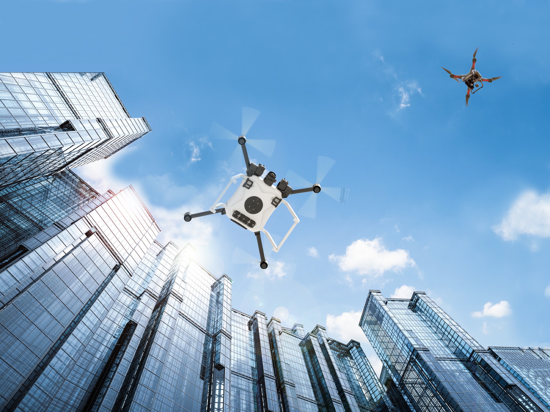 new era of flight no words 0 0 atmx.jpg Autonomous vehicle drones in flight among city buildings.