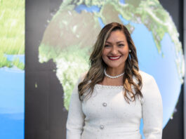 Dr. Yaítza Luna-Cruz: Program Executive at NASA Yaíta smiles broadly at the camera wearing a white dress with a pearl necklace. Her hair is long with curls and she