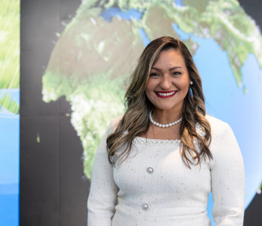 Dr. Yaítza Luna-Cruz: Program Executive at NASA Yaíta smiles broadly at the camera wearing a white dress with a pearl necklace. Her hair is long with curls and she